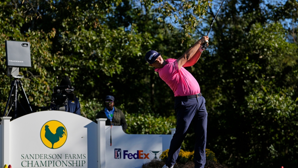 Gary Woodland’s wayward tee shot lands in a cup holder