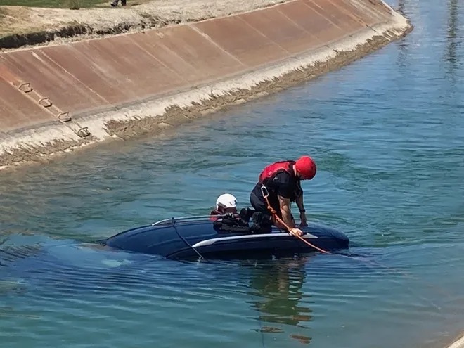 Golfer, official rescue driver from car in California canal