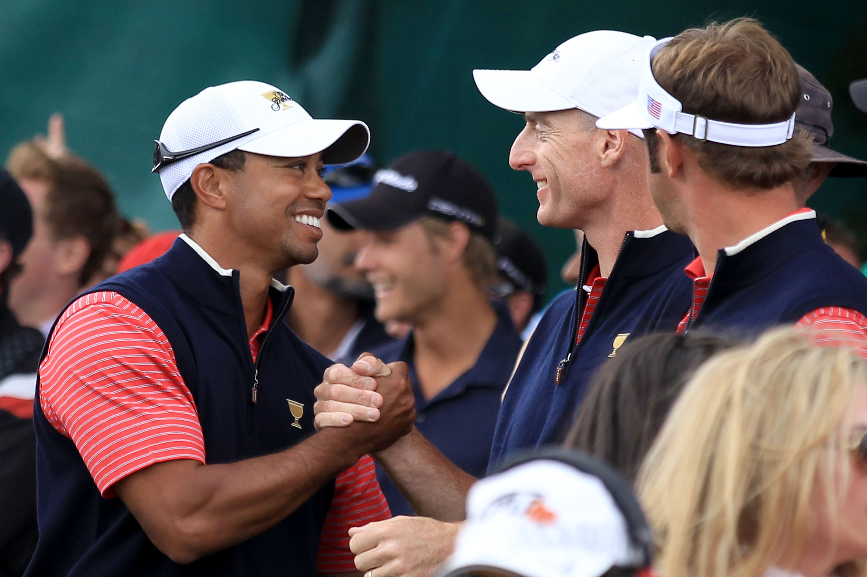 Tiger Woods of the U.S. shakes hands with teammate Jim Furyk after Woods clinched the Presidents Cup with a 4-and-3 victory over Aaron Baddeley.Tiger Woods of the U.S. shakes hands with teammate Jim Furyk after Woods clinched the Presidents Cup with a 4-and-3 victory over Aaron Baddeley.