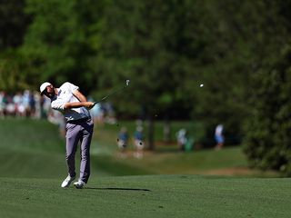 Scottie Scheffler hitting an iron shot from the fairway at Augusta National