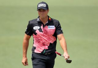 Viktor Hovland walks down the fairway whilst wearing an Azalea polo