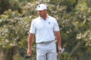 Bryson DeChambeau lines up a putt on the green