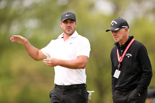 Brooks Koepka and Pete Cowen chat during the 2023 PGA Championship