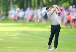 Brooks Koepka hits an iron shot from the fairway