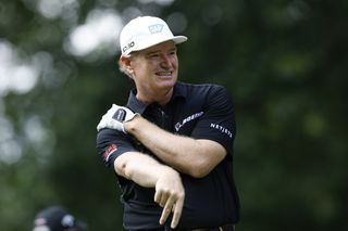 Ernie Els holds his right shoulder whilst waiting to tee off