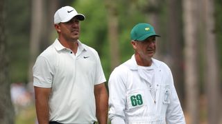 Brooks Koepka and Ricky Elliott during the 2023 Masters