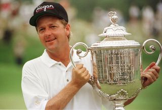 Mark Brooks holding up the 1996 PGA Championship trophy