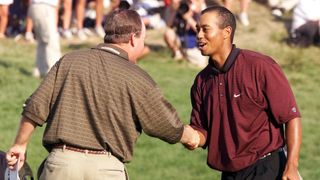Tiger Woods shakes hands with Bob May after their final putts on the 18th hole ahead of a playoff in the 82nd PGA Championship at Valhalla Golf Club in Louisville, KY.