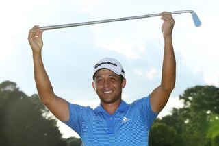 Xander Schauffele holds a putter in celebration of winning the 2017 Tour Championship