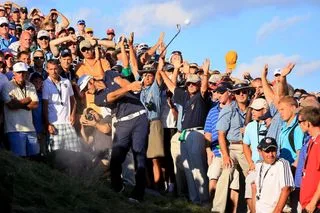 Dustin Johnson strikes a second shot at the 18th hole at Whistling Straits