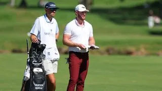 Grayson Murray and his caddie discuss a shot