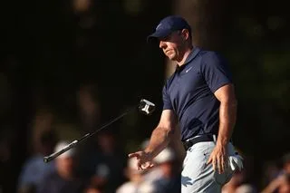 Rory McIlroy drops his putter after a missed putt