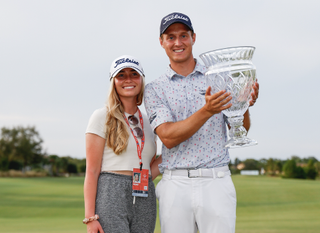 Tim Widing and his wife pose with a trophy
