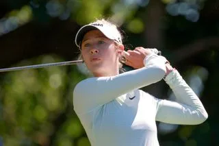 Nelly Korda strikes a tee shot and watches its flight