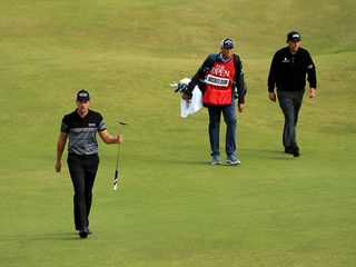 Henrik Stenson walking onto the green at Royal Troon with Phil Mickelson and his caddie behind