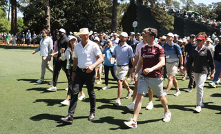 Greg Norman walking with patrons at the 2024 Masters