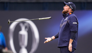 Shane Lowry catches his putter in the air