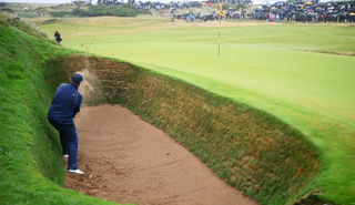 Shane Lowry hits out a bunker at the eighth hole at Royal Troon