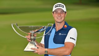 Viktor Hovland poses with the FedEx Cup trophy