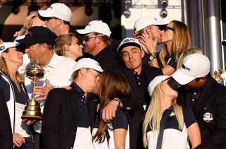 Rickie Fowler shrugs his shoulders whilst posing alongside the US Ryder Cup team in 2016