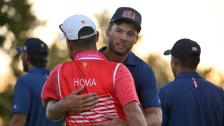 Sam Burns hugs Max Homa's caddie