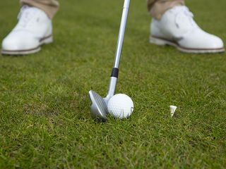 A golf ball with a tee in the ground in front of it - demonstrating the drills explained by Golf Monthly Top 50 Coach Peter Finch