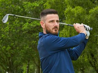 Barry Plummer watching the golf ball after hitting an iron shot