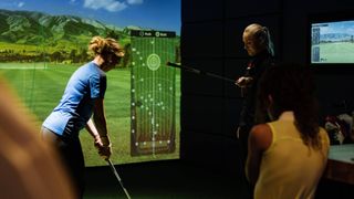 Charley Hull gives a lesson to a female golfer