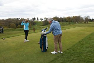 Golfer looking in another player's bag