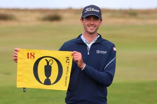 Elvis Smylie holds up an Open flag after reaching the 2024 Open Championship at Royal Troon via Open Qualifying at Royal Cinque Ports Golf Club