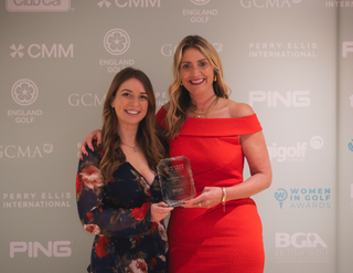 Two women from The Grove holding their award