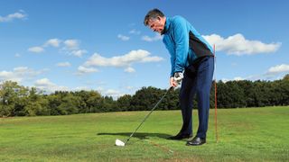 Clive Tucker demonstrates a drill to help golfers stop thinning the golf ball