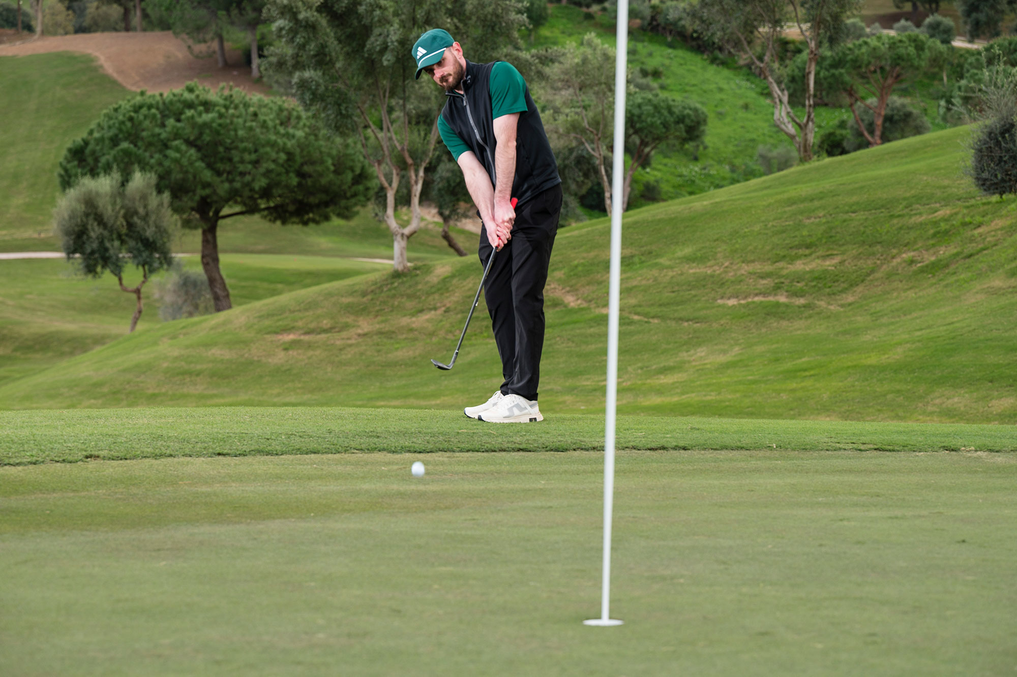 Barry Plummer chipping from the side of the 18th green at La Cala golf resort in Spain