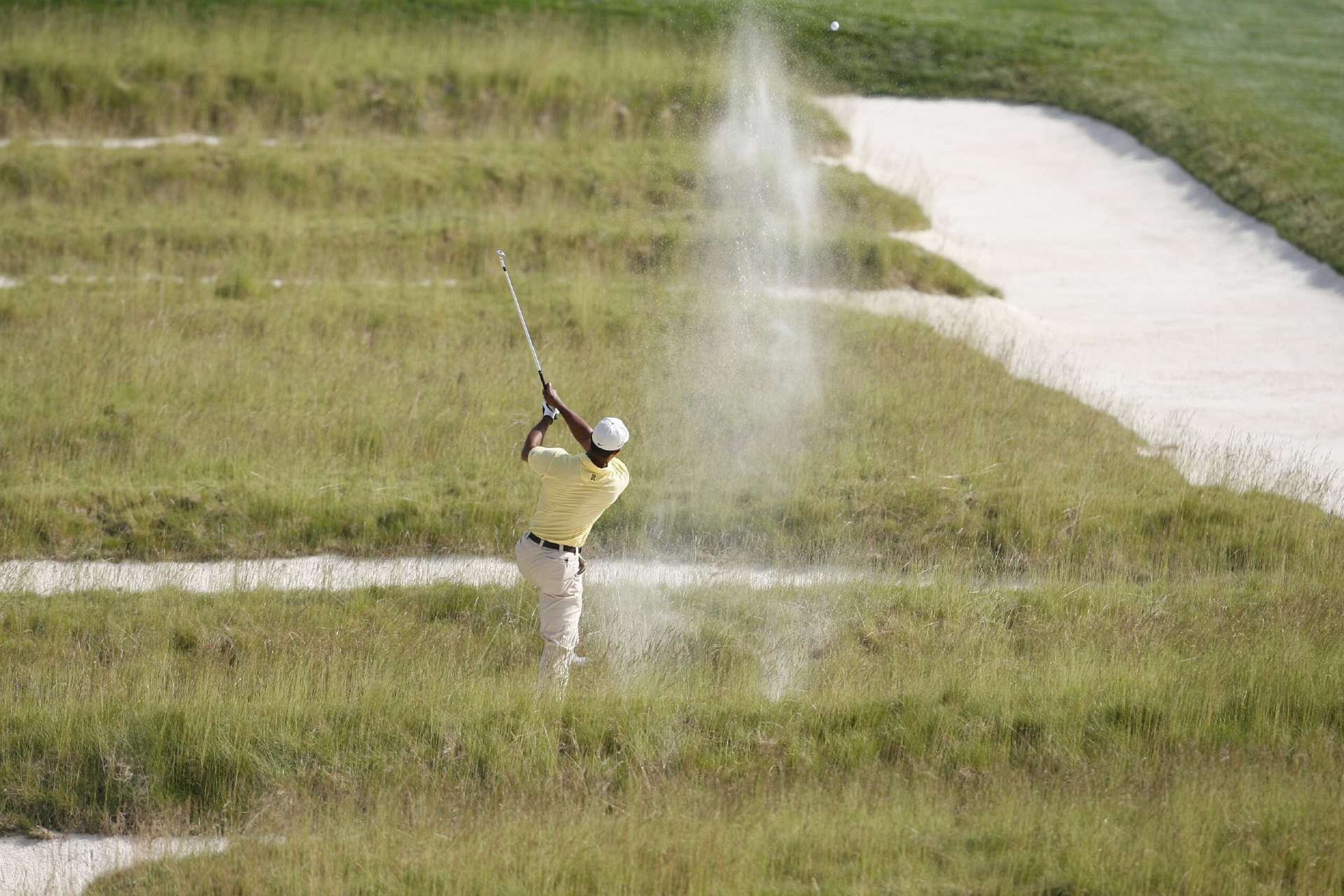Tiger Woods hits a shot out the Church Pew bunker in 2007