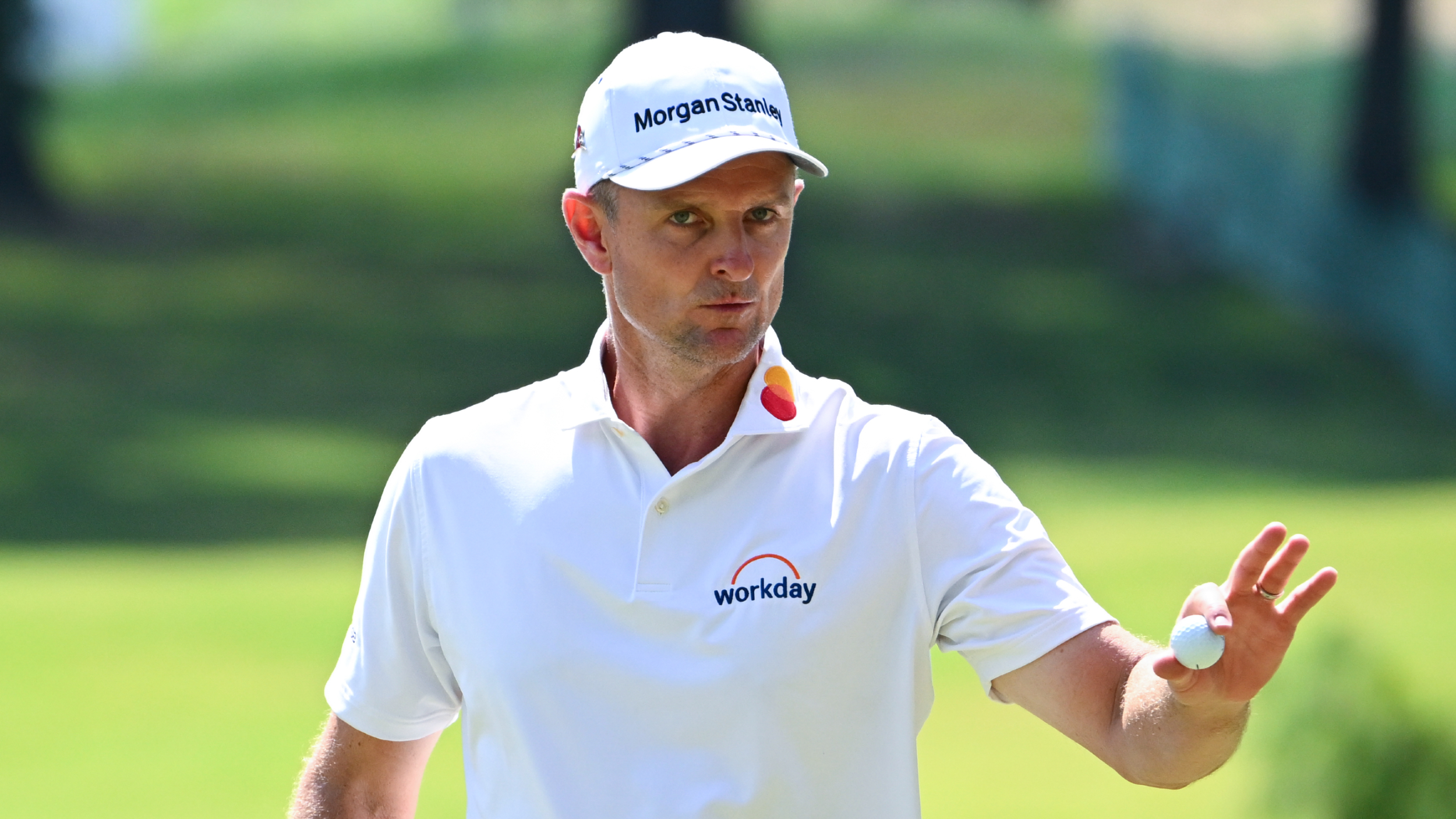 Justin Rose acknowledges the fans in an event
