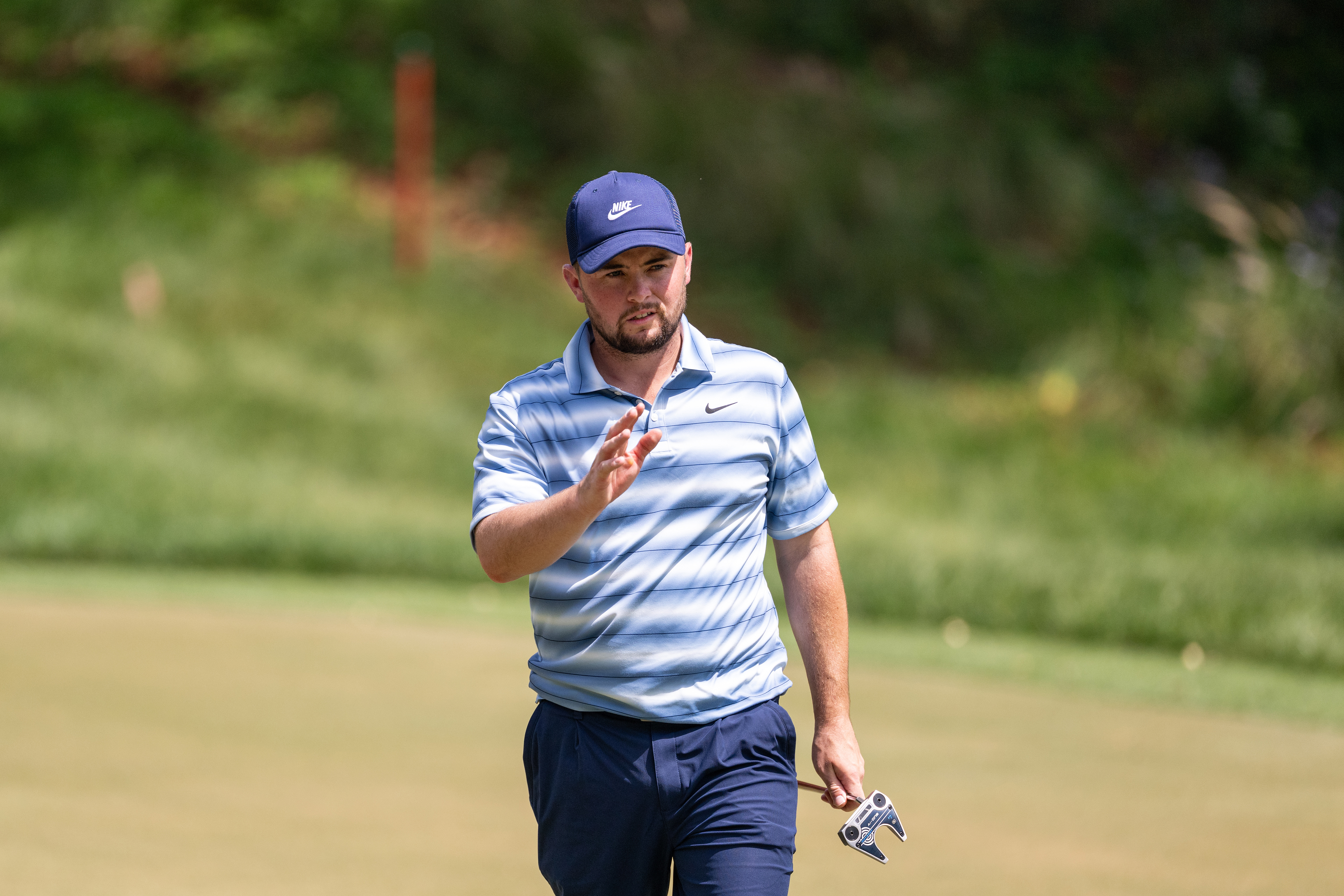 Alex Fitzpatrick acknowledges the crowd after holing his putt on hole 16 on day four of the Hero Indian Open